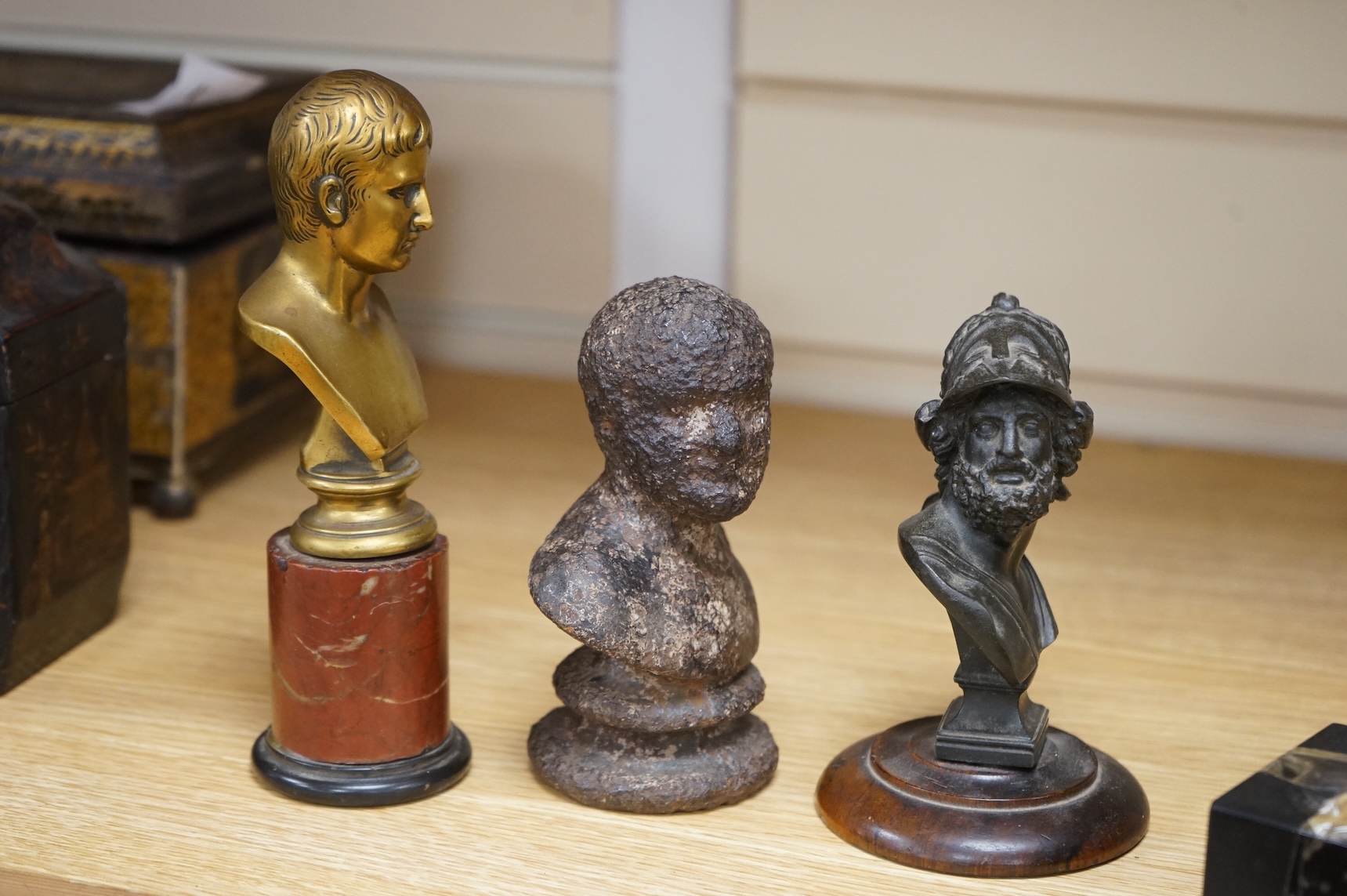A bronze bust of Napoleon, a bust of Ajax and a cast iron bust of an Emperor, tallest 18cm